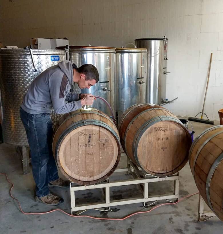 Wine - from Tanks to Barrels - Silas filling a barrel.
