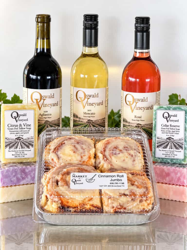 Oswald Vineyard shown on a table - wine, tallow soap and cinnamon rolls.