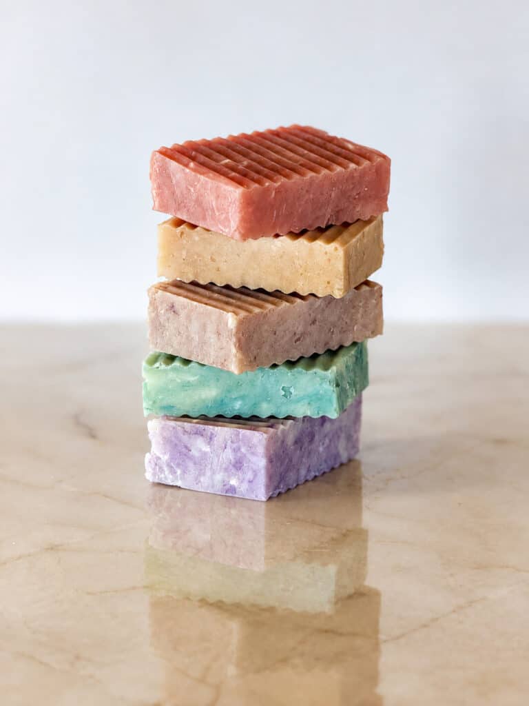 Wine-Inspired Grass Fed Tallow Soap from The Market at Oswald Vineyard shown in different flavors stacked up.